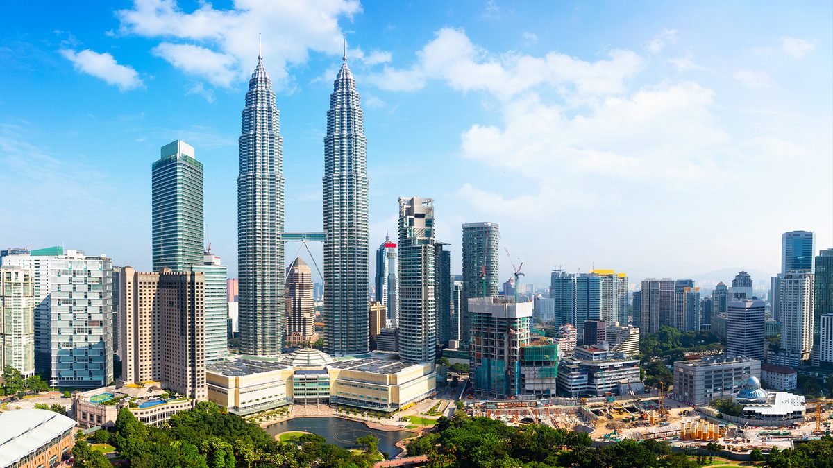The Petronas Towers integrated into the KL skyline, symbolising urban development