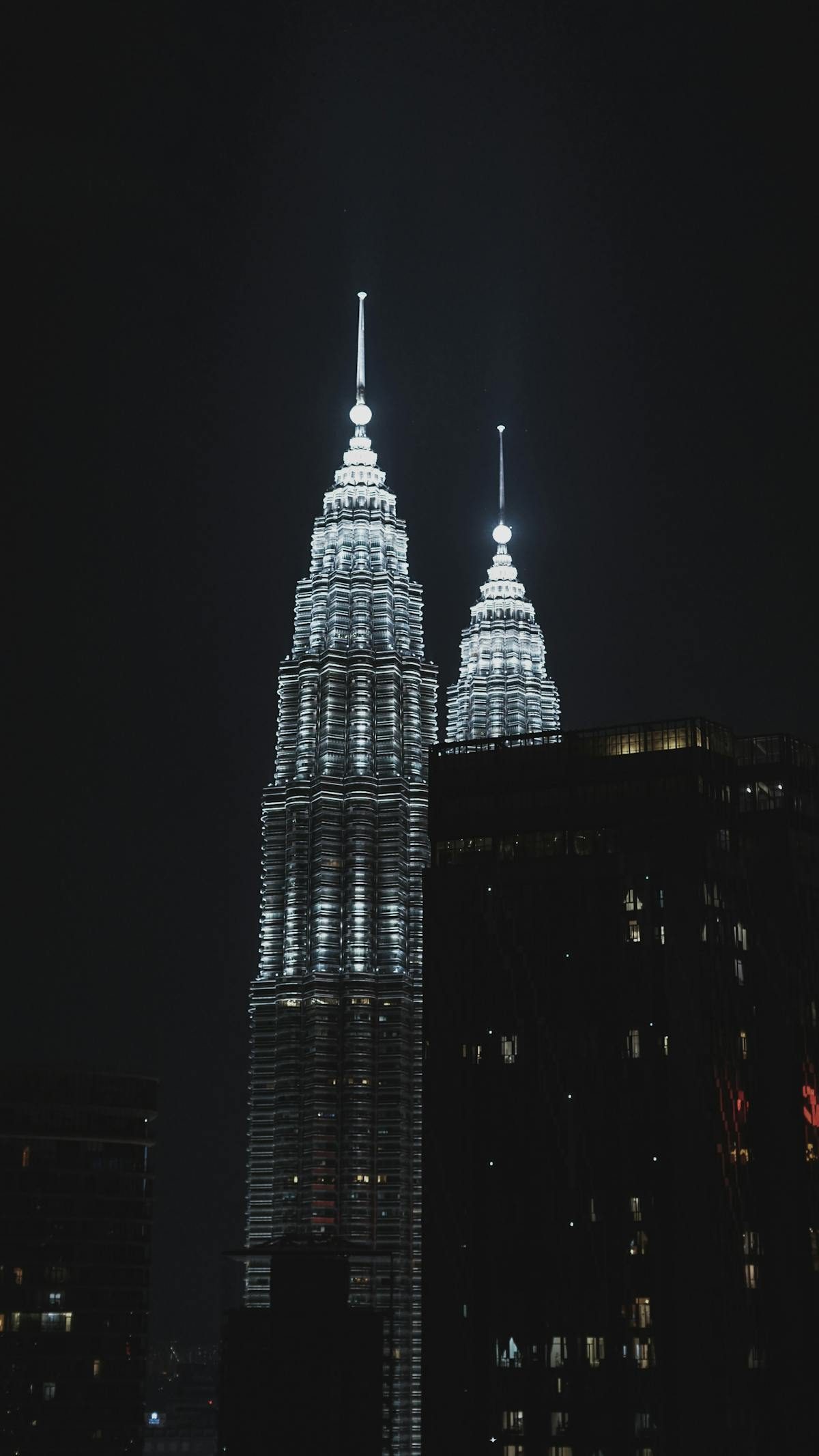 The Petronas Twin Towers illuminated against the night sky