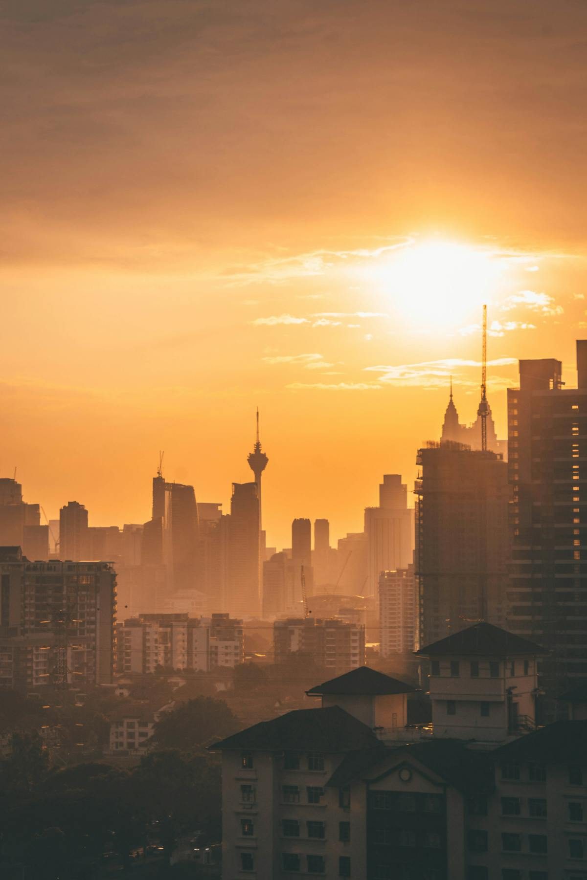 Petronas Twin Towers during golden hour with warm sunlight on the facades